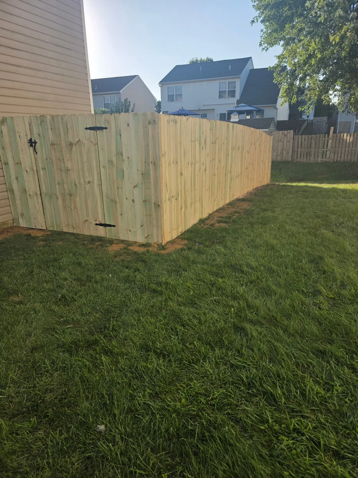 Wood privacy fence with custom gate installation
