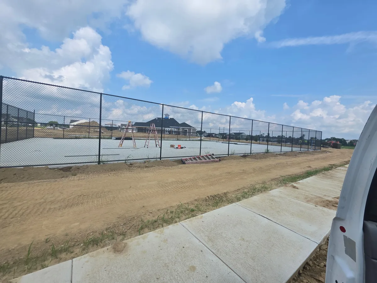 Black vinyl-coated chain link fence ideal for containing dogs