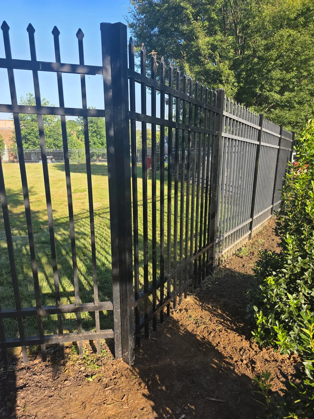 Black aluminum ornamental spear top fence installation in Delaware