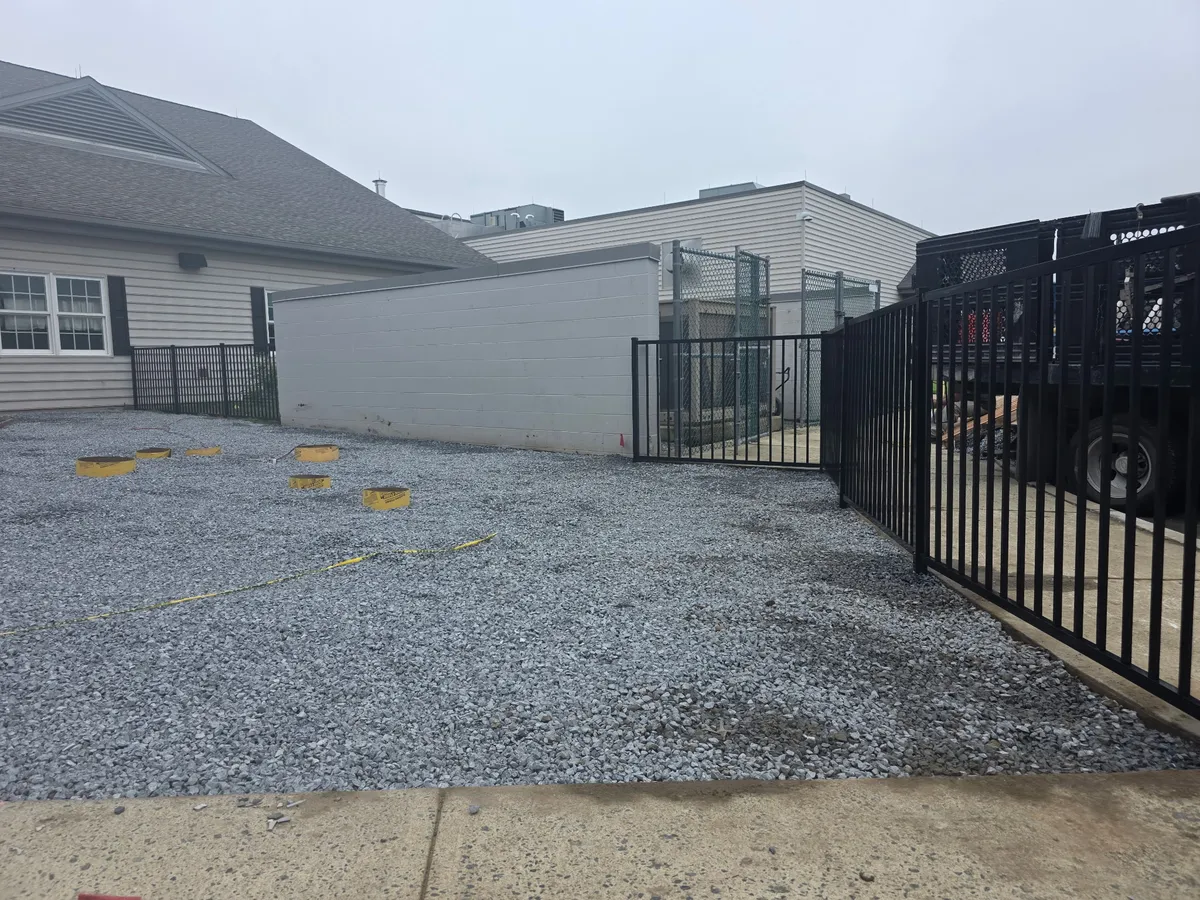 Black aluminum ornamental fence with gate at commercial property